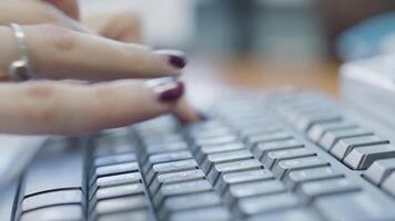 Close-up of woman typing on keyboard. Action. Beautiful female hands with manicure quickly type on keyboard. Woman accountant or writer types on keyboard video