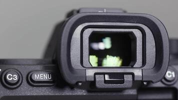 Close up of a new camera vizier isolated on grey background. Action. Viewfinder of a professional photo or video camera.