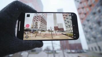 detailopname van scherm van telefoon nemen video. actie. hand- Holding telefoon terwijl het schieten video schudt klein. het schieten videos Aan uw telefoon in koel weer