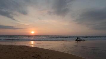 Beautiful seascape with calm sea and setting sun. Action. Beautiful sunset on sandy beach. Sandy beach with quiet waves and setting sun on horizon video