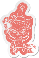 cute quirky cartoon distressed sticker of a cat wearing santa hat png