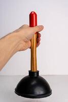 Man using plunger to clear sink blockage on white background with copy space photo