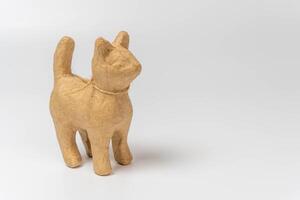 Realistic papier mache cat sculpture on white background with copy space photo