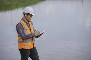 Environmental engineers inspect water quality,Bring water to the lab for testing,Check the mineral content in water and soil,Check for contaminants in water sources. photo