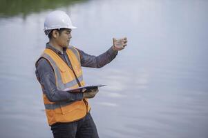 Environmental engineers inspect water quality,Bring water to the lab for testing,Check the mineral content in water and soil,Check for contaminants in water sources. photo