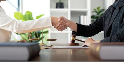 Businesswoman handshake to seal a deal judge female lawyers consultation legal services consulting in regard to the various contract to plan the case in court photo