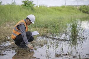 Environmental engineers inspect water quality,Bring water to the lab for testing,Check the mineral content in water and soil,Check for contaminants in water sources. photo