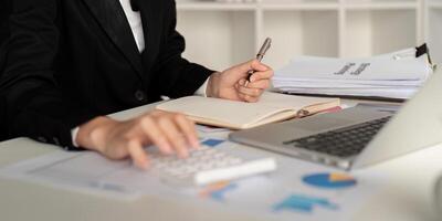 Documents, Business woman and accountant reading report for information, financial data or analysis. Paperwork, auditor check, review and bookkeeping, Calculate finance and tax in office photo
