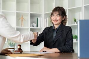 Businesswoman handshake to seal a deal judge female lawyers consultation legal services consulting in regard to the various contract to plan the case in court photo