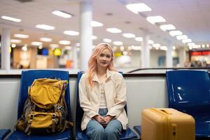 Happy asian tourist woman with backpack and luggage traveling between waits for flight in airport terminal, Tourist journey trip concept photo