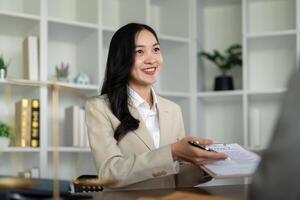 Lawyers woman and businesswoman discussing contract papers sitting at the table. Concepts of law, advice, legal service photo