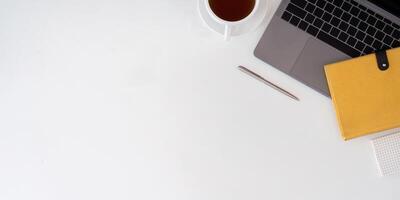 Top view with copy space for your text. Laptop computer and cup of coffee on white background photo