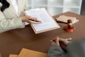 Consultation and conference of lawyer and business people discussion at law firm in office. Concepts of law, Judge gavel with scales of justice photo