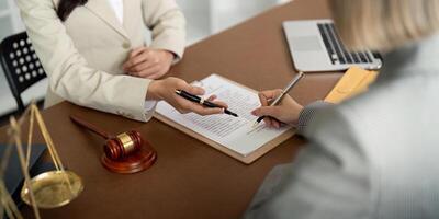 Consultation and conference of lawyer and business people discussion at law firm in office. Concepts of law, Judge gavel with scales of justice photo