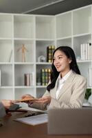 Lawyers woman and businesswoman discussing contract papers sitting at the table. Concepts of law, advice, legal service photo