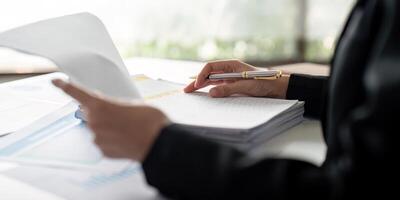 Documents, Business woman and accountant reading report for information, financial data or analysis. Paperwork, auditor check, review and bookkeeping, Calculate finance and tax in office photo