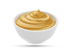 Mustard in bowl isolated on white background photo