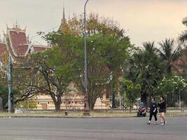 Wat Pha That Luang Temple in the Morning people passing by, vientuane, Laos, 3 rd March, 2024 photo