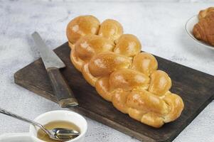 a bread loaf on a cutting board with a knife photo