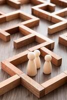 Wooden miniature at the start point of puzzle maze wood block. Leadership concept. photo