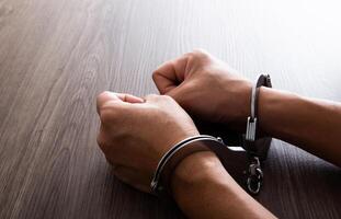 Arrested Man's Hand With Handcuffs photo