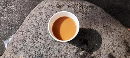 AI generated cup of coffee on a large rock photo