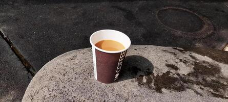 AI generated cup of coffee on a large rock photo