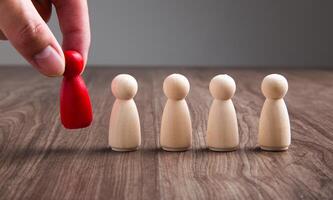 Businessman hand choose people standing out from the crowd. photo