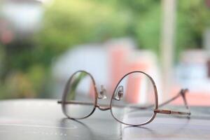 Eyeglasses on table, progressive lenses, eyeglasses for the elderly, glasses progressive lens, eyeglass progressive lens, close-up of glasses on lenses test, looking through glasses photo