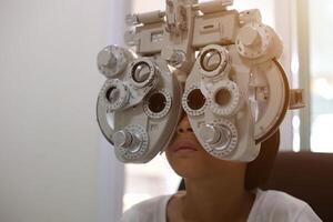 Child eye exam, kid eye test, Phoropter eye test photo