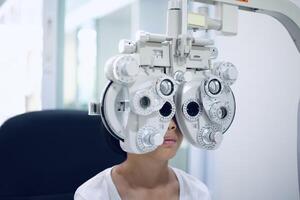 Child eye exam, kid eye test, Phoropter eye test photo