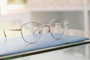 Eyeglasses on table, progressive lenses, eyeglasses for the elderly, glasses progressive lens, eyeglass progressive lens, close-up of glasses on lenses test, looking through glasses photo