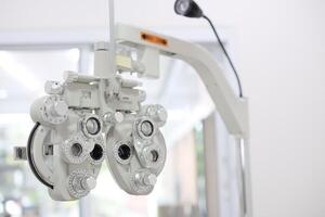 Phoropter for eye test, lenses glasses for eye check in optical store photo