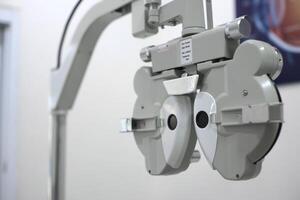 Phoropter for eye test, lenses glasses for eye check in optical store photo