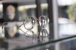 Eyeglasses on table, progressive lenses, eyeglasses for the elderly, glasses progressive lens, eyeglass progressive lens, close-up of glasses on lenses test, looking through glasses photo