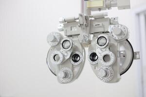 Phoropter for eye test, lenses glasses for eye check in optical store photo