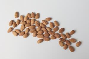 Almond on white background, brown almonds photo