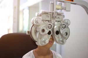 Child eye exam, kid eye test, Phoropter eye test photo