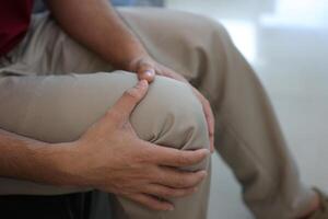 Knee massage to relieve pain, osteoarthritis, knee pain, knee inflammation photo