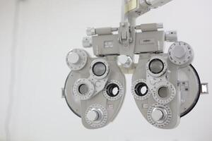 Phoropter for eye test, lenses glasses for eye check in optical store photo