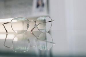 Eyeglasses on table, progressive lenses, eyeglasses for the elderly, glasses progressive lens, eyeglass progressive lens, close-up of glasses on lenses test, looking through glasses photo