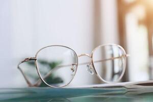 Eyeglasses on table, progressive lenses, eyeglasses for the elderly, glasses progressive lens, eyeglass progressive lens with sunlight, close-up of glasses on blur background, looking through glasses photo