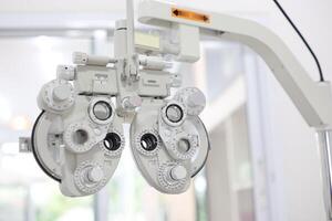Phoropter for eye test, lenses glasses for eye check in optical store photo