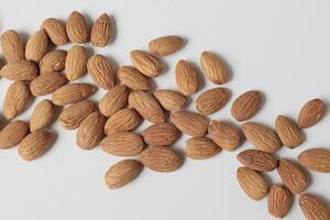 Almond on white background, brown almonds photo