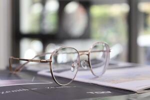 Eyeglasses on table, progressive lenses, eyeglasses for the elderly, glasses progressive lens, eyeglass progressive lens, close-up of glasses on lenses test, looking through glasses photo