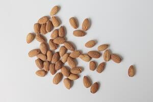 Almond on white background, brown almonds photo