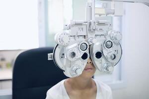 Child eye exam, kid eye test, Phoropter eye test photo