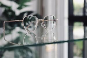 Eyeglasses on table, progressive lenses, eyeglasses for the elderly, glasses progressive lens, eyeglass progressive lens, close-up of glasses on lenses test, looking through glasses photo