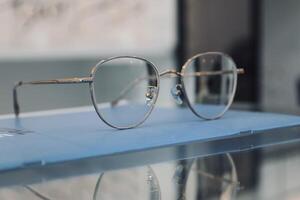 Eyeglasses on table, progressive lenses, eyeglasses for the elderly, glasses progressive lens, eyeglass progressive lens, close-up of glasses on lenses test, looking through glasses photo