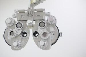 Phoropter for eye test, lenses glasses for eye check in optical store photo